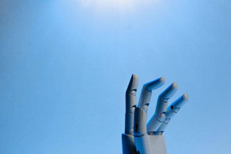 White robot hand against a blue background